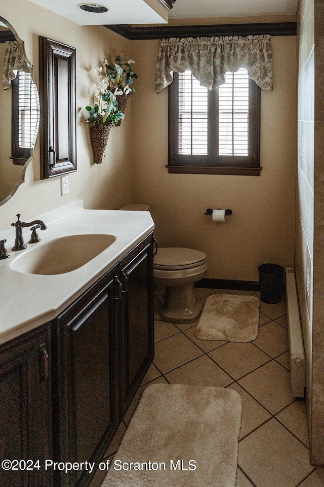 bathroom with tile patterned floors, radiator, vanity, and toilet