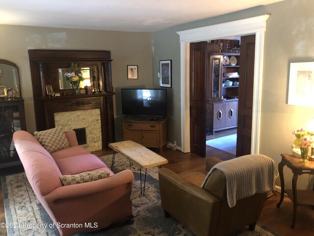 living room featuring dark hardwood / wood-style floors, separate washer and dryer, and a fireplace