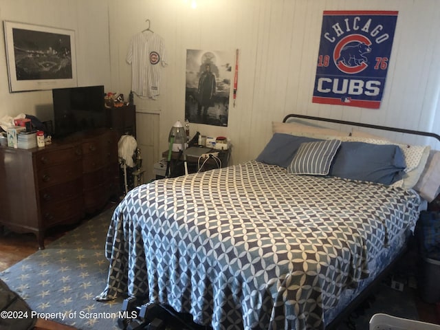 bedroom with wood walls