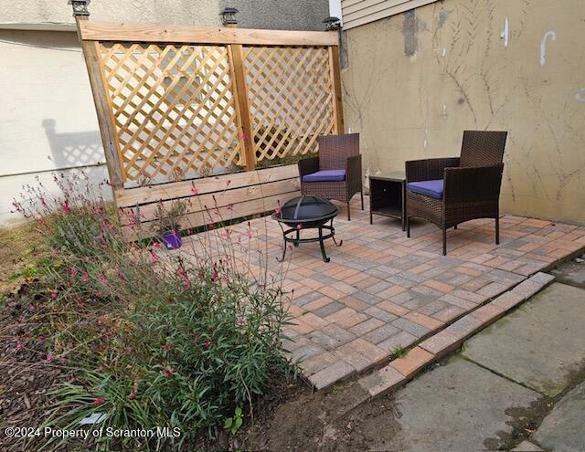 view of patio / terrace with an outdoor fire pit