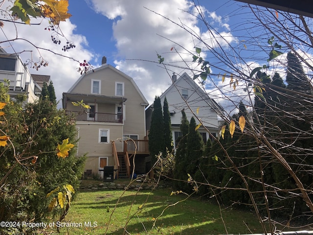 825 Prescott Ave, Scranton, PA 18510 - rear view of property with a gambrel roof, stairs, a lawn, and a balcony