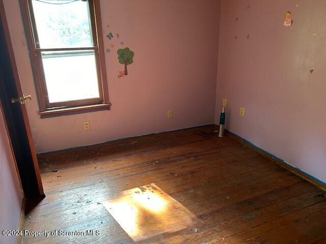 empty room with hardwood / wood-style floors