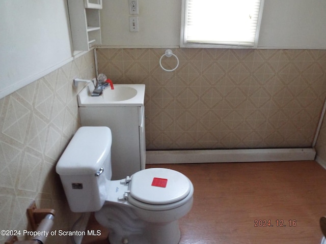 75 Hamlin Hwy, Moscow, PA 18444 - half bathroom with toilet, tile walls, wainscoting, wood finished floors, and vanity