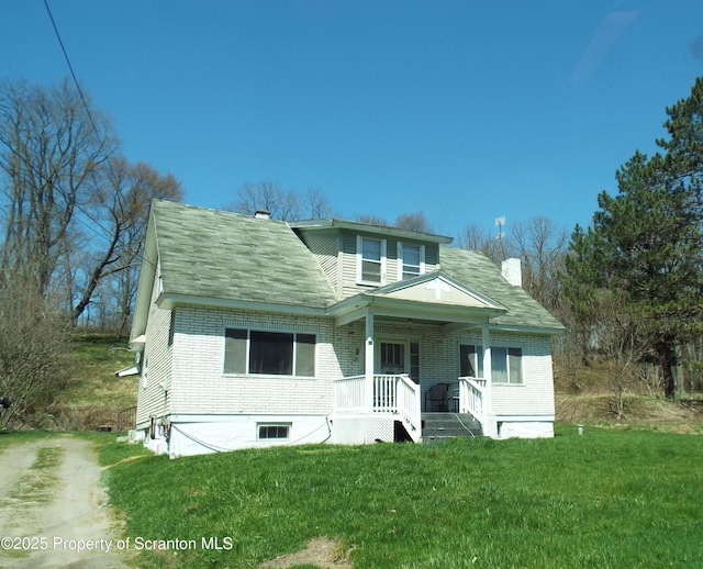 75 Hamlin Hwy, Moscow, PA 18444 - bungalow-style home with a chimney, a front lawn, brick siding, and a porch