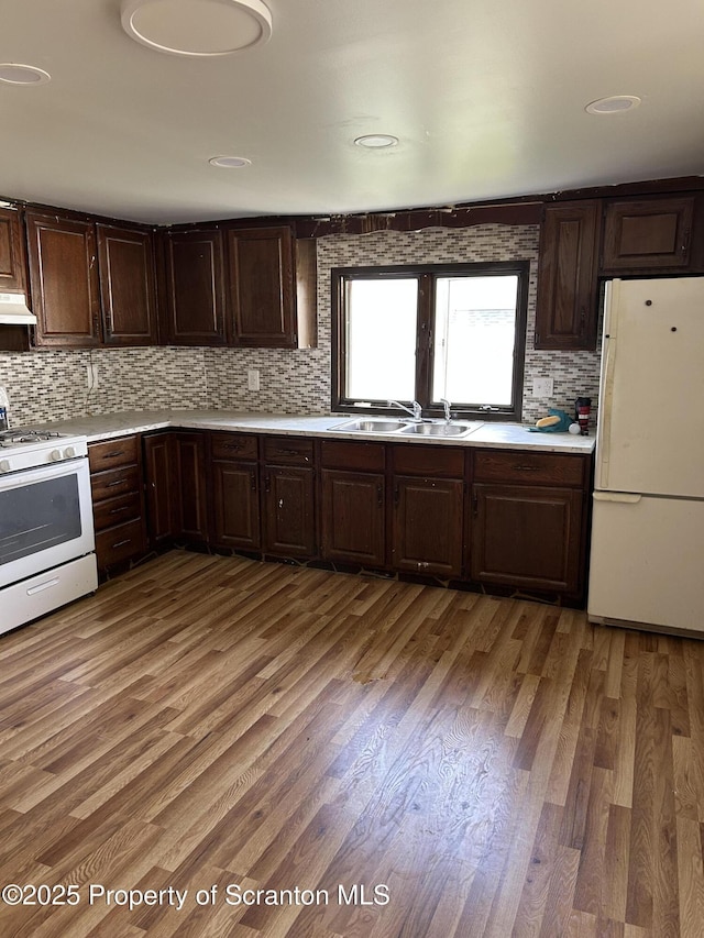 210 Gorham Ave, Mayfield, PA 18433 - kitchen featuring white appliances, a sink, light countertops, backsplash, and dark brown cabinets