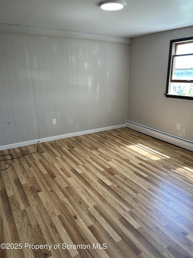 210 Gorham Ave, Mayfield, PA 18433 - spare room with wood finished floors and a baseboard radiator