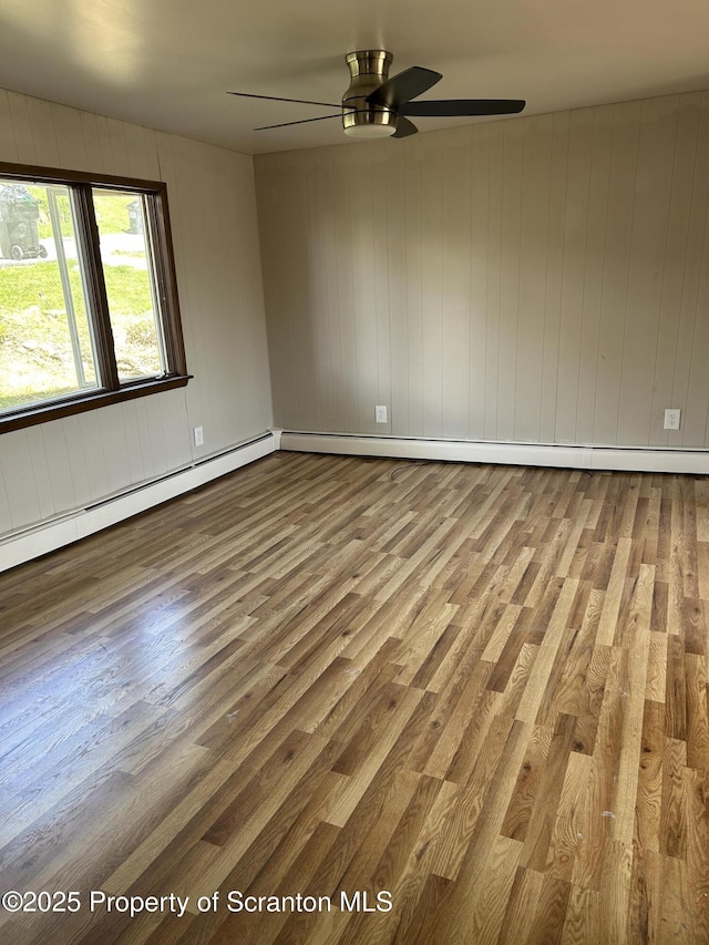 210 Gorham Ave, Mayfield, PA 18433 - empty room featuring wood finished floors, ceiling fan, and a baseboard radiator