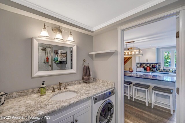 266 Warren Park Rd, New Milford, PA 18834 - full bath with washer / clothes dryer, vanity, wood finished floors, and ornamental molding