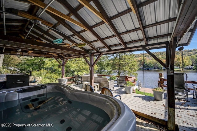266 Warren Park Rd, New Milford, PA 18834 - wooden deck with a water view, a hot tub, and view of wooded area
