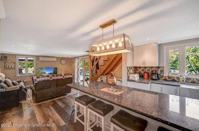 266 Warren Park Rd, New Milford, PA 18834 - kitchen featuring open floor plan, dark wood finished floors, an AC wall unit, healthy amount of natural light, and recessed lighting