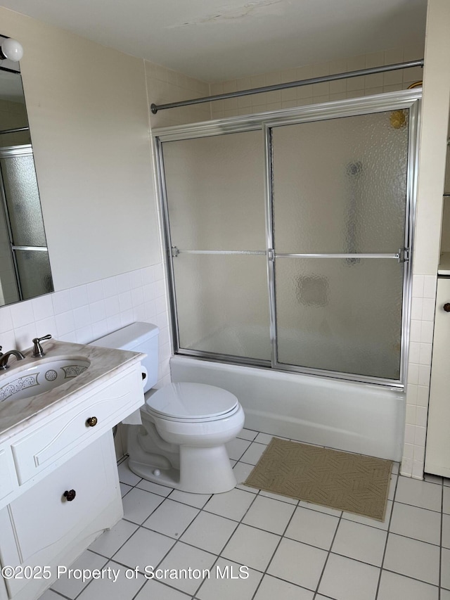 550 Clay Ave Unit 8C, Scranton, PA 18510 - full bath with tile walls, vanity, bath / shower combo with glass door, tile patterned floors, and a wainscoted wall