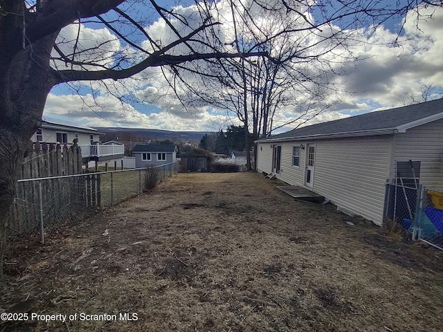 view of yard featuring entry steps and a fenced backyard