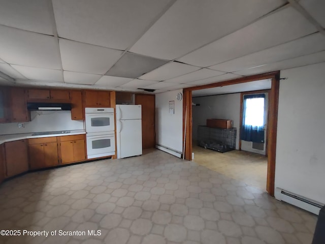 kitchen with white appliances, a baseboard radiator, under cabinet range hood, and light countertops