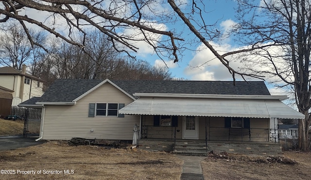 view of front of home featuring a porch and a shingled roof