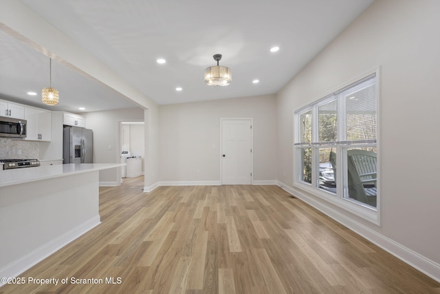 828 Lake Henry Rd, Lake Ariel, PA 18436 - unfurnished living room featuring an inviting chandelier, baseboards, recessed lighting, and light wood-type flooring