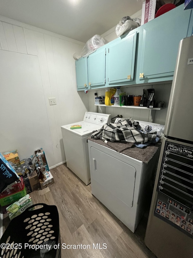 717719 Cedar Ave, Scranton, PA 18505 - laundry room featuring cabinet space, washing machine and dryer, and light wood finished floors