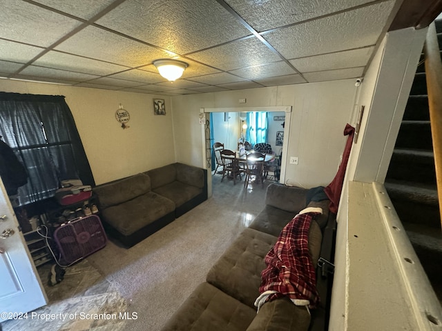 living room with a drop ceiling