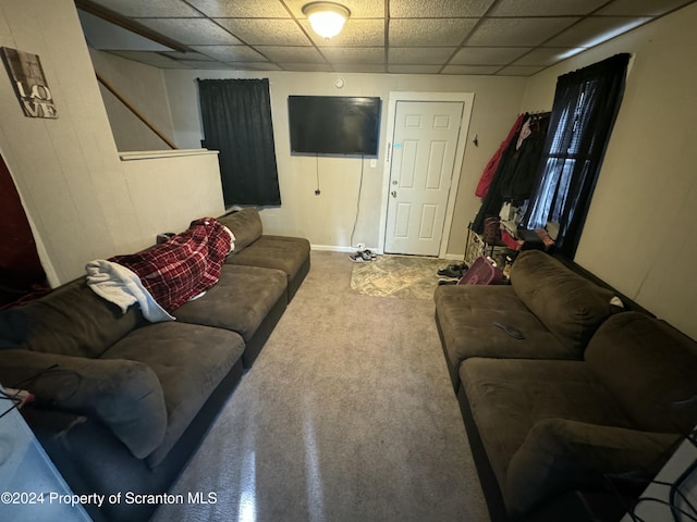 carpeted living room featuring a paneled ceiling