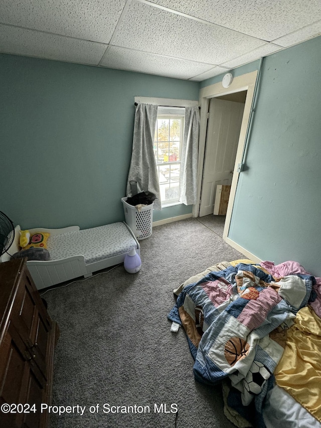 bedroom with carpet and a paneled ceiling