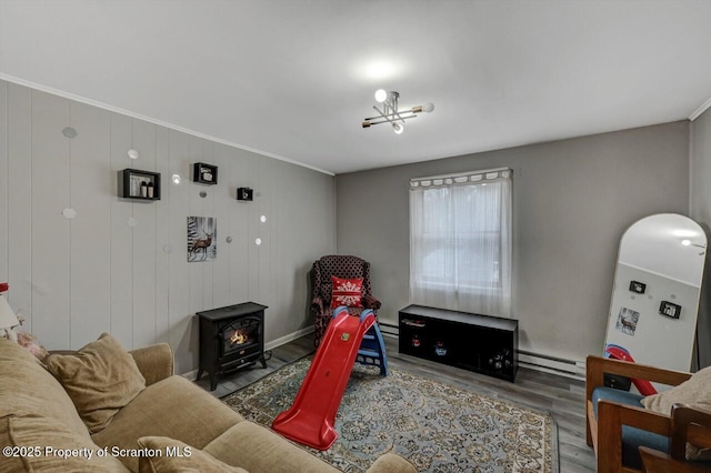 living room featuring arched walkways, a baseboard heating unit, wood finished floors, a wood stove, and crown molding