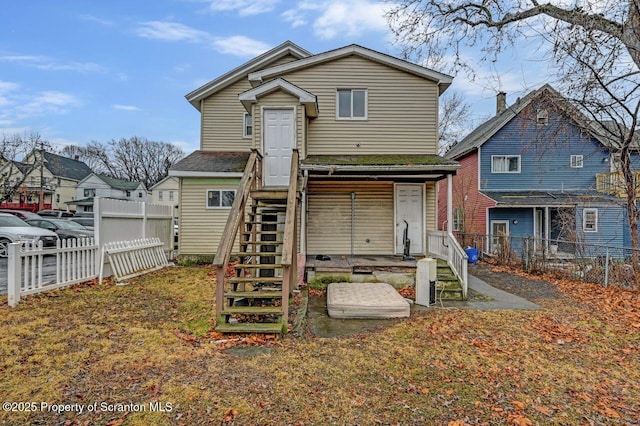 back of house with stairs and fence