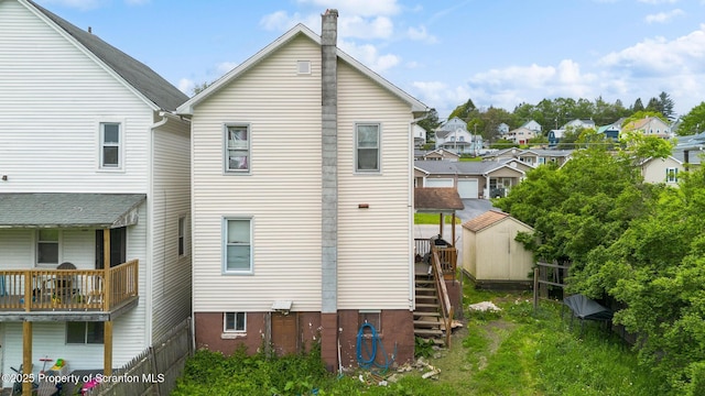 424 Hudson St, Forest City, PA 18421 - view of side of property featuring a chimney, stairs, and a residential view