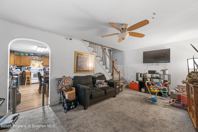 424 Hudson St, Forest City, PA 18421 - living room with a ceiling fan, stairs, light colored carpet, and arched walkways