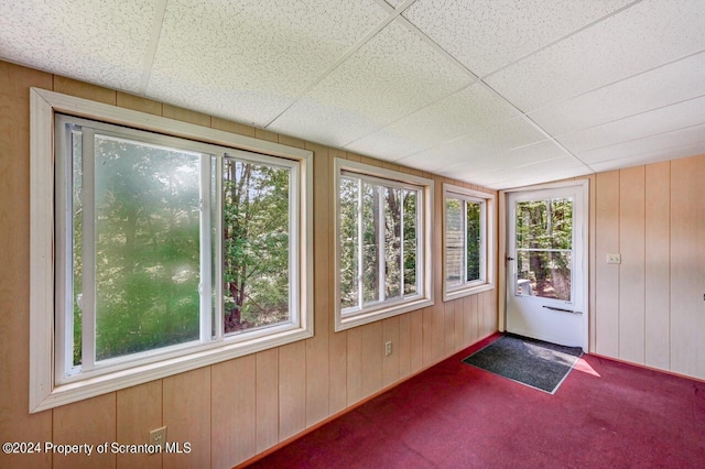 unfurnished sunroom featuring a drop ceiling