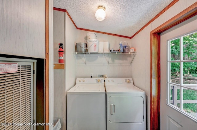 washroom featuring a textured ceiling, independent washer and dryer, and ornamental molding