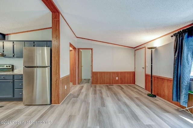 interior space featuring a textured ceiling, lofted ceiling, ornamental molding, and light hardwood / wood-style flooring