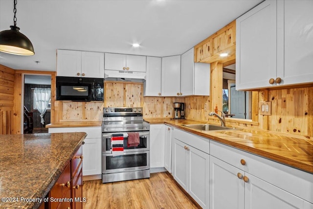 kitchen featuring white cabinets, pendant lighting, and range with two ovens