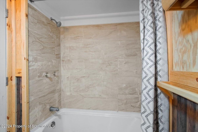 bathroom featuring shower / tub combo with curtain