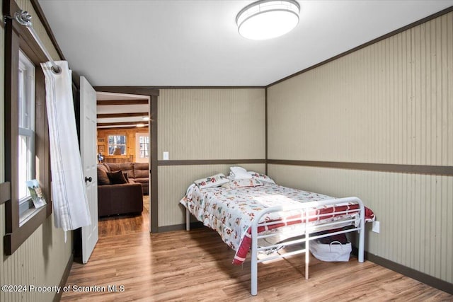 bedroom featuring hardwood / wood-style flooring and crown molding