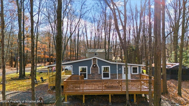 rear view of property with a wooden deck