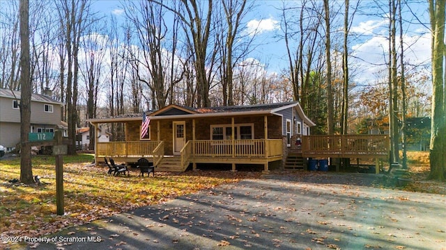 view of front of property featuring covered porch and a wooden deck