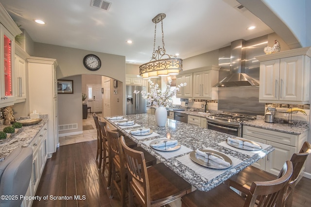 224 Shadow Wood Cir, Archbald, PA 18403 - dining room with dark wood-type flooring, visible vents, recessed lighting, and arched walkways
