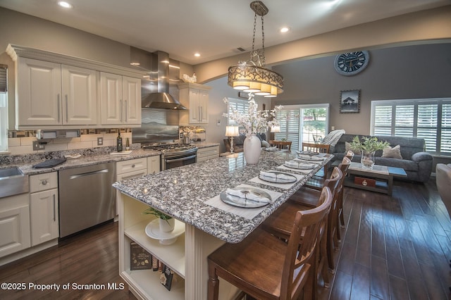 224 Shadow Wood Cir, Archbald, PA 18403 - kitchen featuring open shelves, white cabinets, light stone countertops, wall chimney exhaust hood, and stainless steel appliances