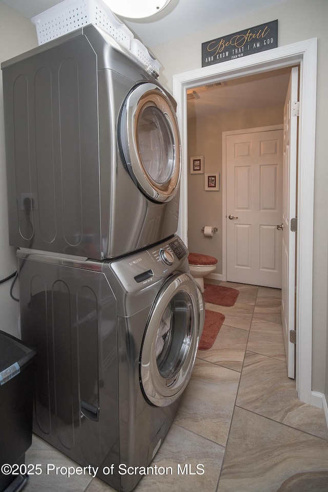 224 Shadow Wood Cir, Archbald, PA 18403 - laundry room featuring baseboards, stacked washer / dryer, and laundry area