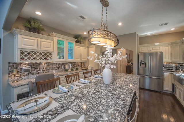 224 Shadow Wood Cir, Archbald, PA 18403 - kitchen with stainless steel fridge with ice dispenser, visible vents, tasteful backsplash, and dark wood-style flooring