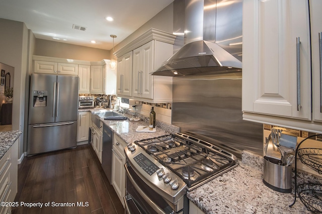 224 Shadow Wood Cir, Archbald, PA 18403 - kitchen with visible vents, exhaust hood, appliances with stainless steel finishes, light stone countertops, and backsplash