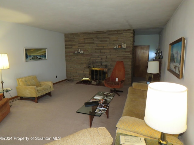 carpeted living room with a stone fireplace