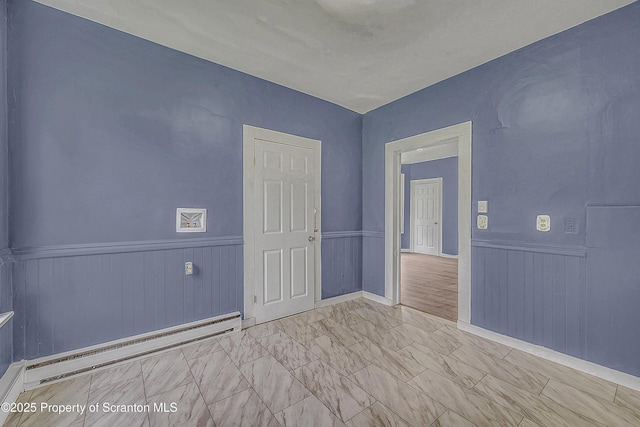 336 Grand Ave, Clarks Summit, PA 18411 - empty room featuring baseboard heating, wainscoting, and marble finish floors