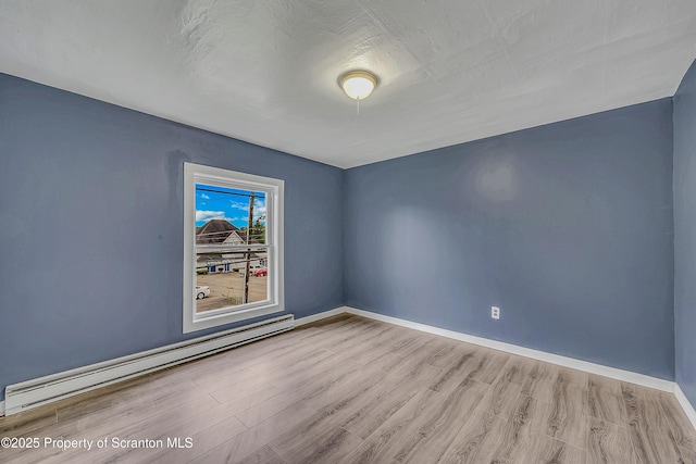336 Grand Ave, Clarks Summit, PA 18411 - spare room featuring a baseboard heating unit and wood finished floors