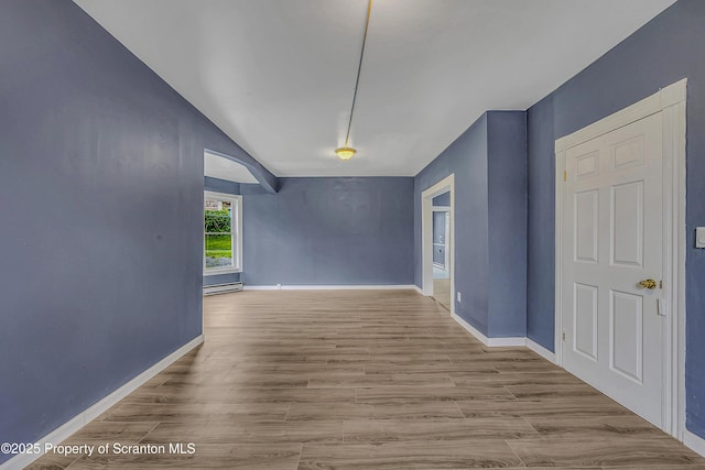 336 Grand Ave, Clarks Summit, PA 18411 - spare room featuring baseboard heating, wood finished floors, and lofted ceiling