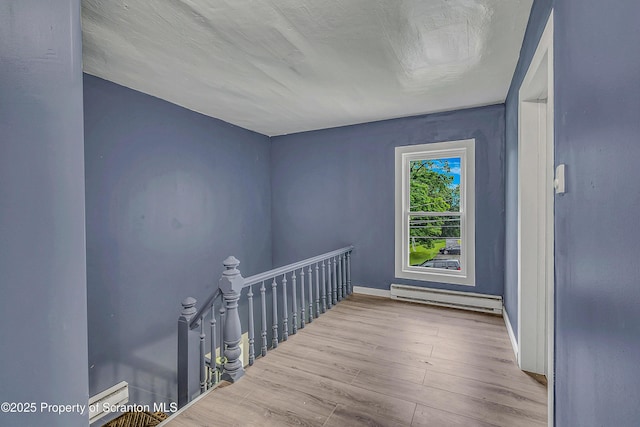 336 Grand Ave, Clarks Summit, PA 18411 - hallway featuring a baseboard radiator, an upstairs landing, and wood finished floors