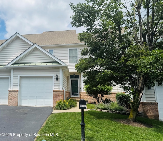 2103 Robinson Close, Moosic, PA 18507 - view of front of house with brick siding, driveway, a front yard, and a garage