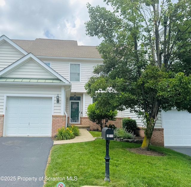 2103 Robinson Close, Moosic, PA 18507 - view of front facade featuring brick siding, a front lawn, asphalt driveway, and roof with shingles