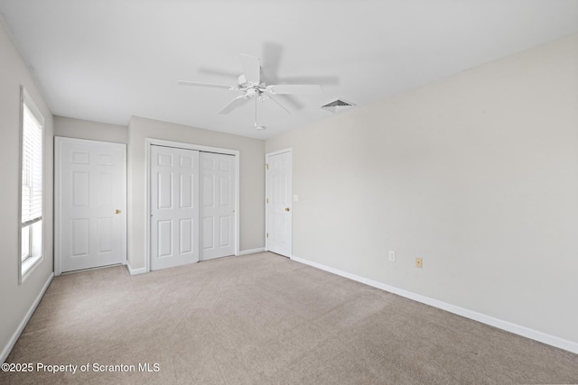 2103 Robinson Close, Moosic, PA 18507 - unfurnished bedroom featuring multiple windows, carpet flooring, a closet, and ceiling fan