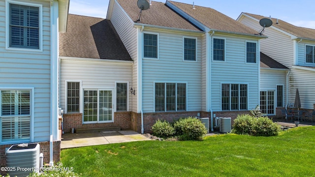 2103 Robinson Close, Moosic, PA 18507 - rear view of house featuring brick siding, a lawn, a patio, and a shingled roof
