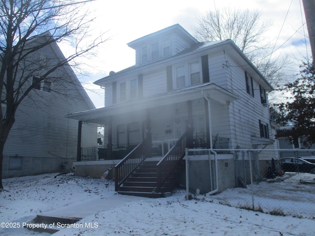 american foursquare style home with covered porch